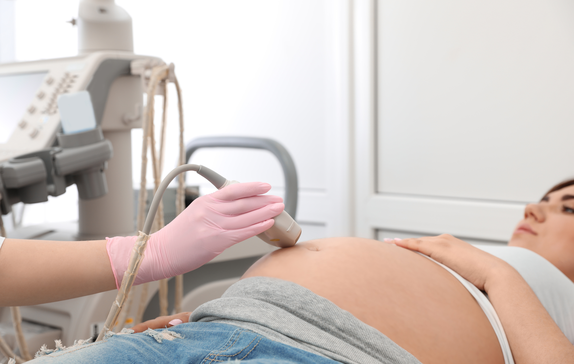 Young pregnant woman undergoing ultrasound scan